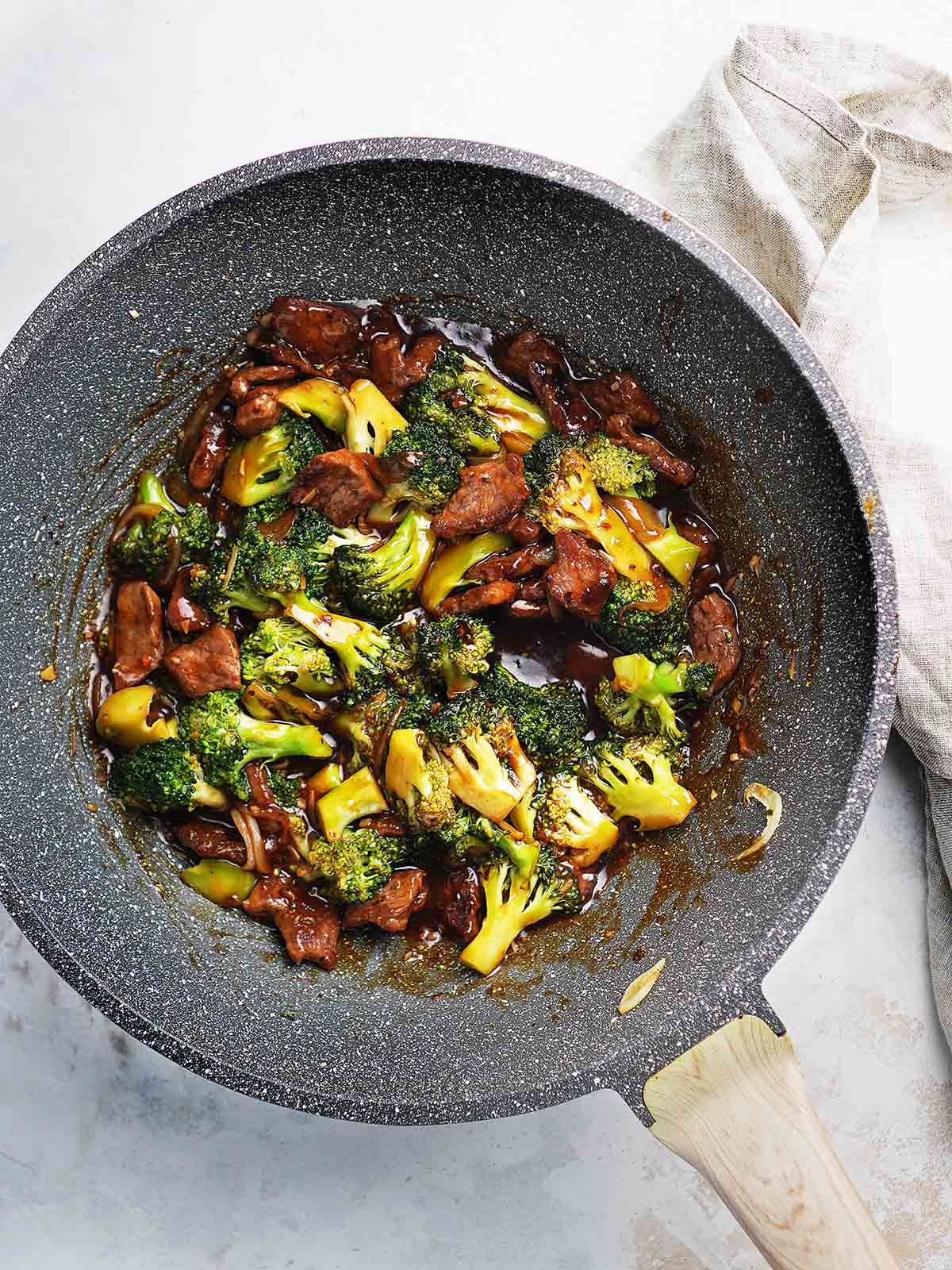A wok with broccoli stir fry.
