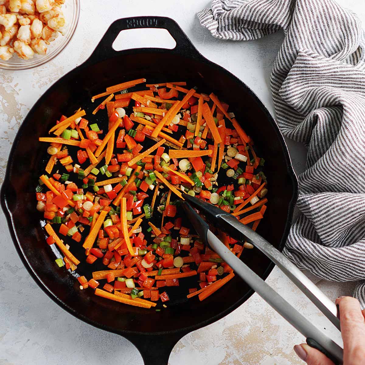 Sauteing vegetables in a skillet.